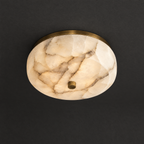 Alabaster Flush Mount Light with Aged Brass Frame on a dark charcoal grey studio ceiling backdrop