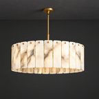 Alabaster Drum Pendant Light with Brass Frame on a dark charcoal grey studio ceiling backdrop