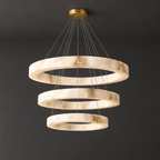 Grand Three-Ring Alabaster LED Chandelier on a dark charcoal grey studio ceiling backdrop