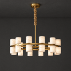 Alabaster Cylinder Chandelier with Brass Frame on a dark charcoal grey studio ceiling backdrop
