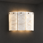Layered Alabaster Wall Sconce on a dark charcoal grey studio wall backdrop