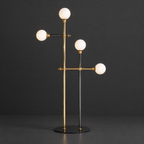 Opaline Globe Floor Lamp with Brass Arms on a dark charcoal grey studio backdrop