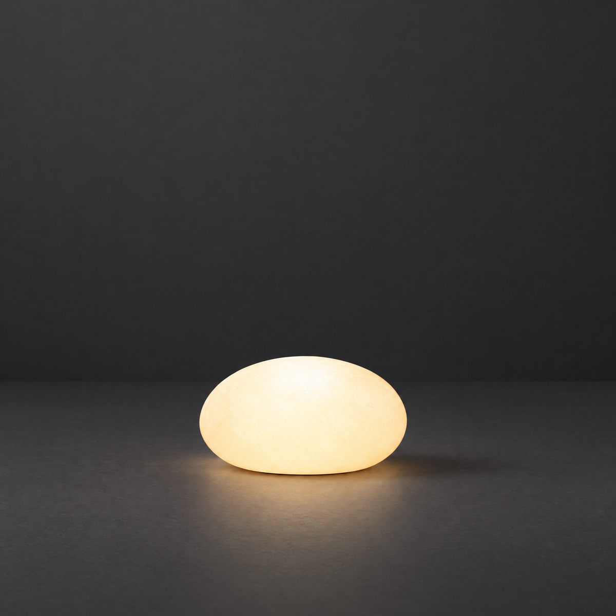 Solar Pebble Stone Garden Lights on a dark charcoal grey studio backdrop