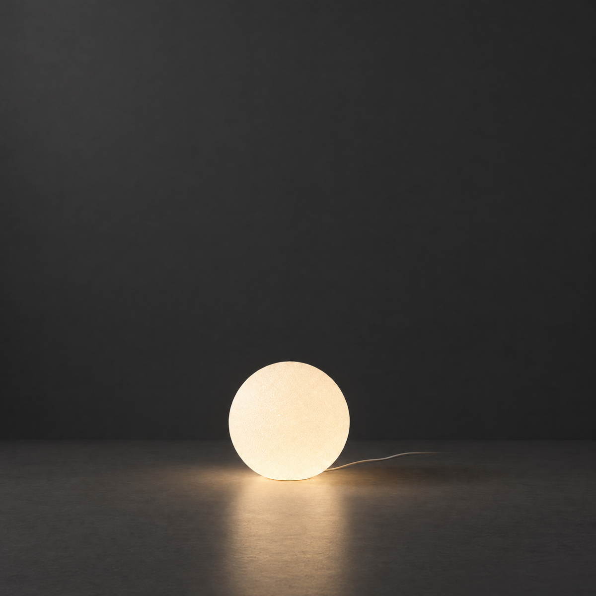 Resin Globe Floor Lamp on a dark charcoal grey studio backdrop