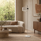 Adjustable Black Arc Floor Lamp in a styled room setting