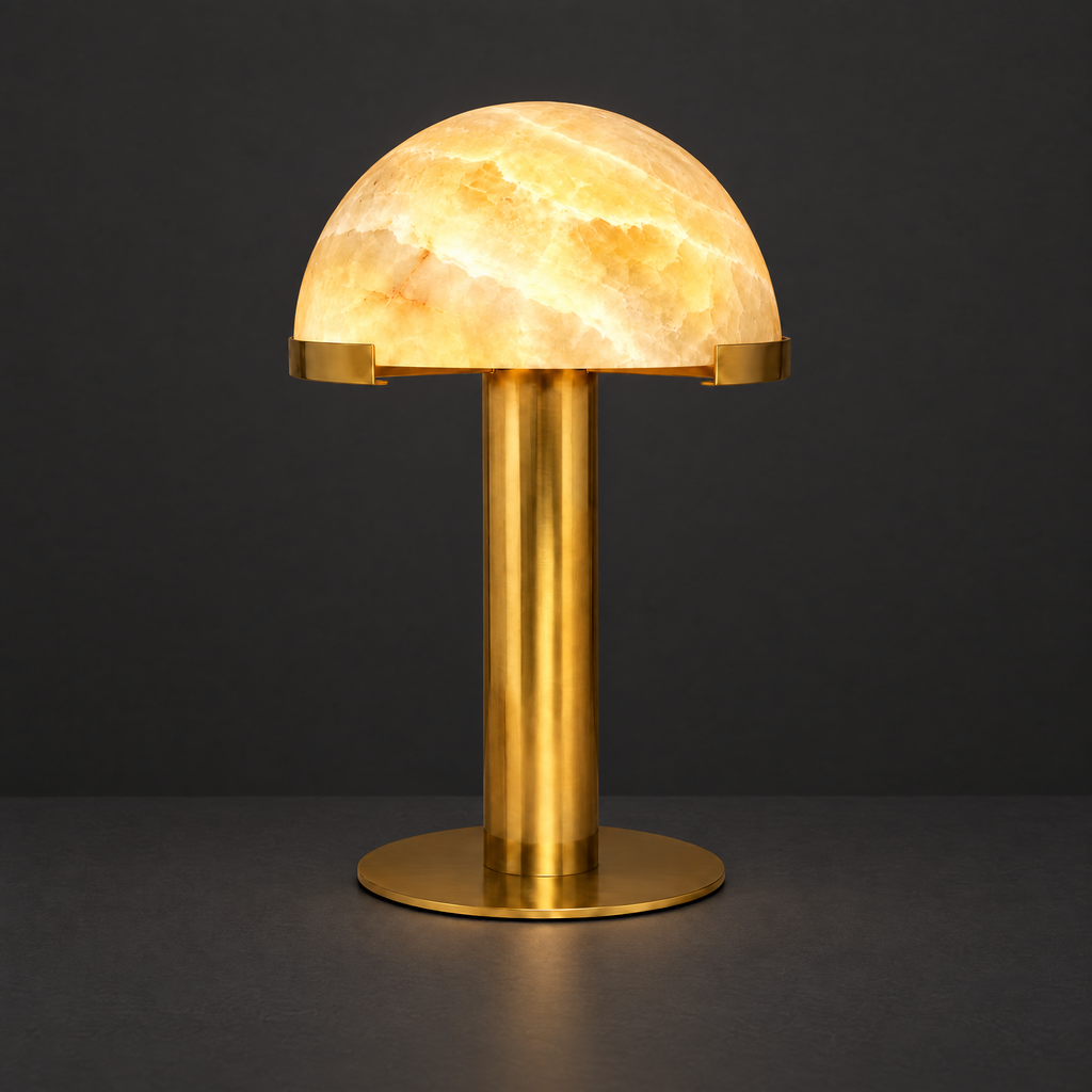 Honey Onyx Dome Table Lamp with Brass Stem on a dark charcoal grey studio backdrop