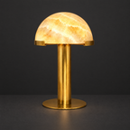 Honey Onyx Dome Table Lamp with Brass Stem on a dark charcoal grey studio backdrop