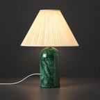 Green Marble Table Lamp with Pleated Shade on a dark charcoal grey studio backdrop