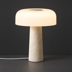 Travertine Table Lamp with Frosted Dome Shade on a dark charcoal grey studio backdrop