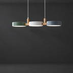Linear Pendant Light with Staggered Shades on a dark charcoal grey studio backdrop
