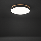 Ultra-Thin Flush Mount Light with Wood Accent on a dark charcoal grey studio backdrop